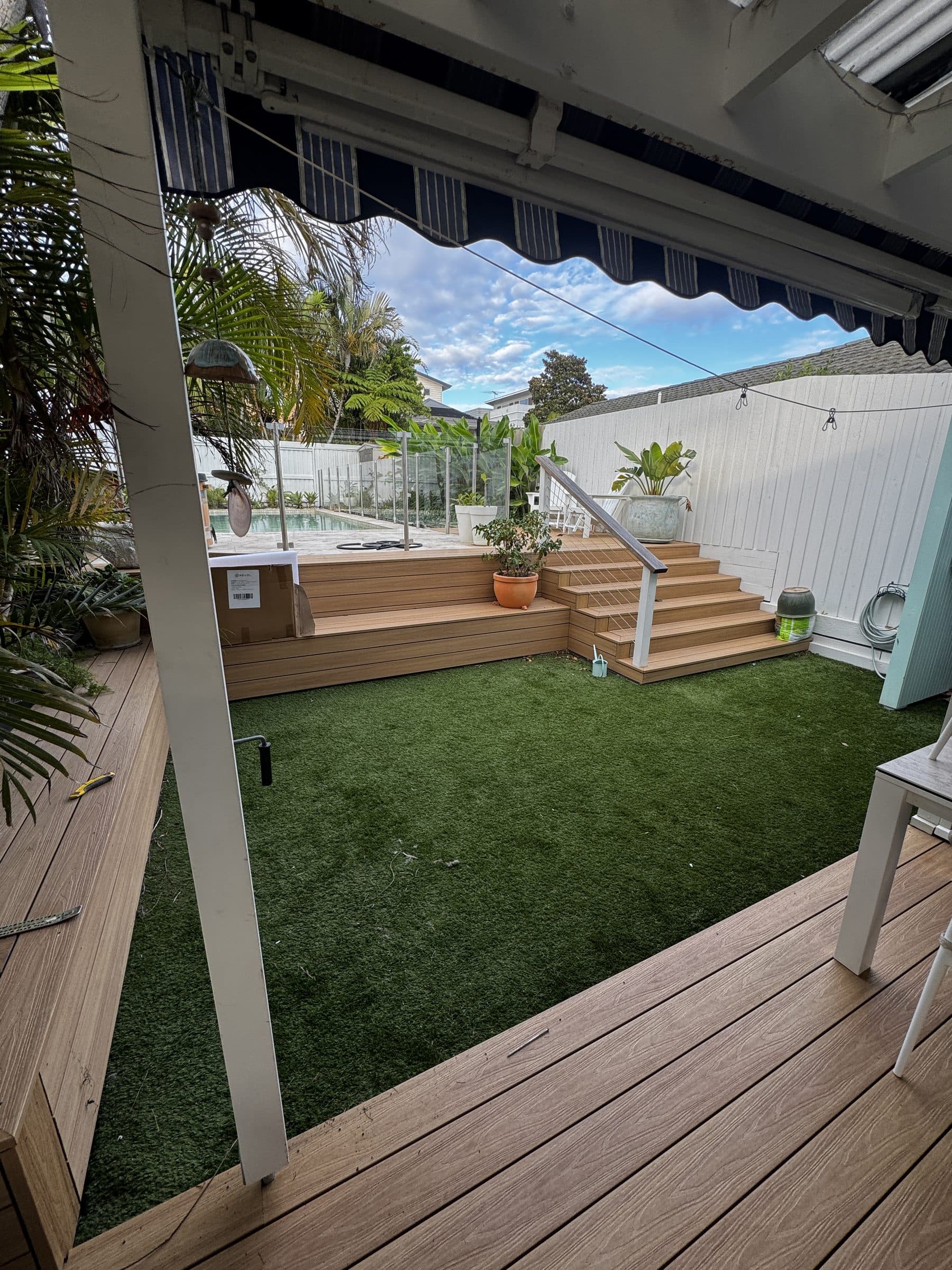 A low-maintenance artificial turf courtyard with a timber deck